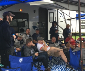 Fans watching the game at their tailgate